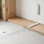 flooring beneath drywall placement